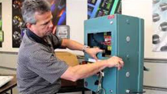 A person opening machinery parts. 