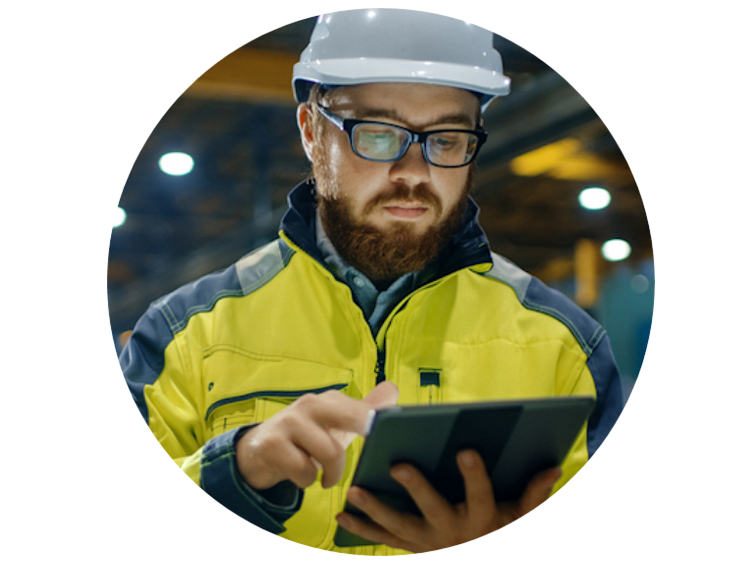 Engineer in a safety helmet looking at a tablet