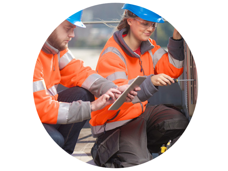 Two technicians working on an electrical panel