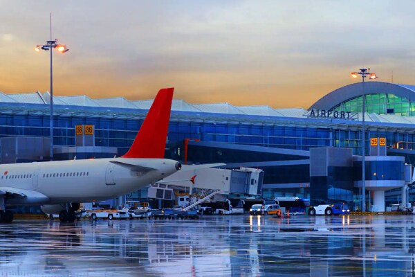 An airport runway on a cloudy evening, with flights parked