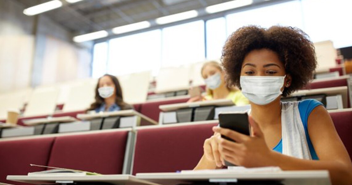 Woman sitting on a class looking mobile phone