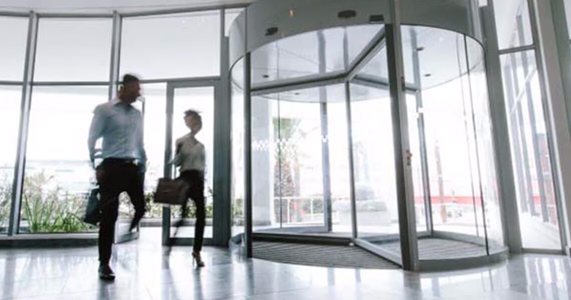 Two people walking in an office lobby
