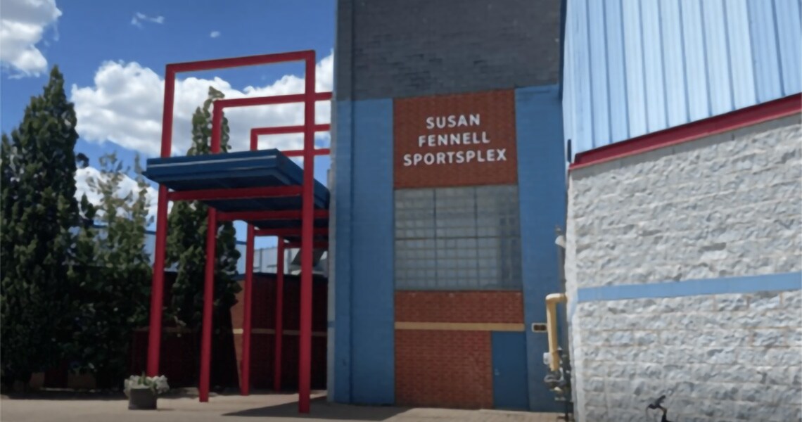 Two skyscrapers lit up at twilight