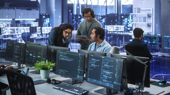 Employees working at their desktops in office