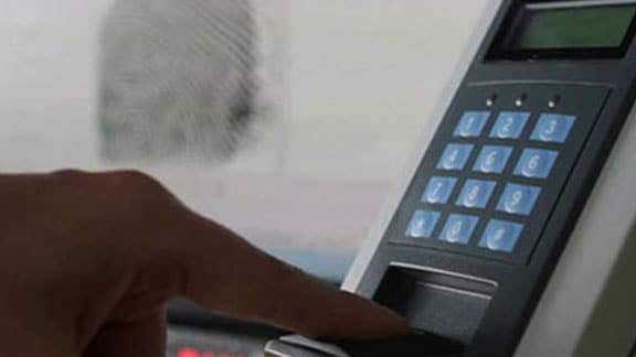 A man giving his fingerprint impression for biometrics access control