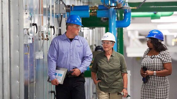 people in factory with safety helmets