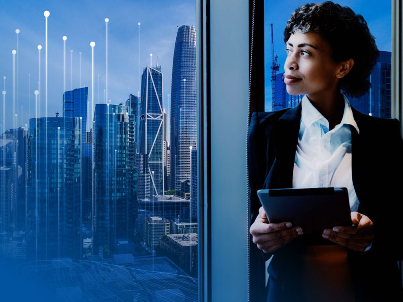 woman looking out cityscape with modern graphics