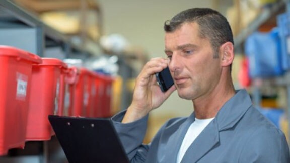 man holding clipboard phone